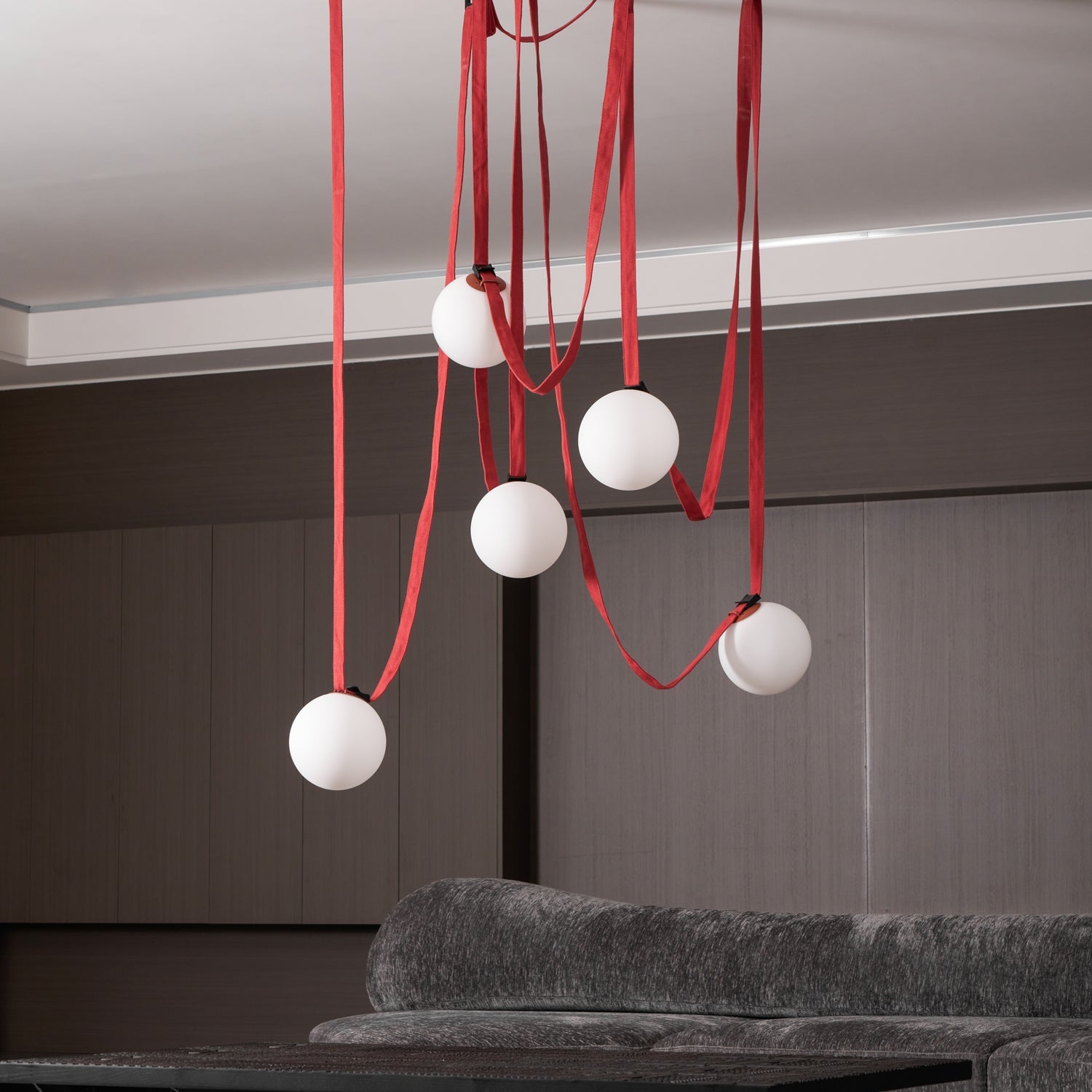 Belt pendant light globes lit against a dark ceiling