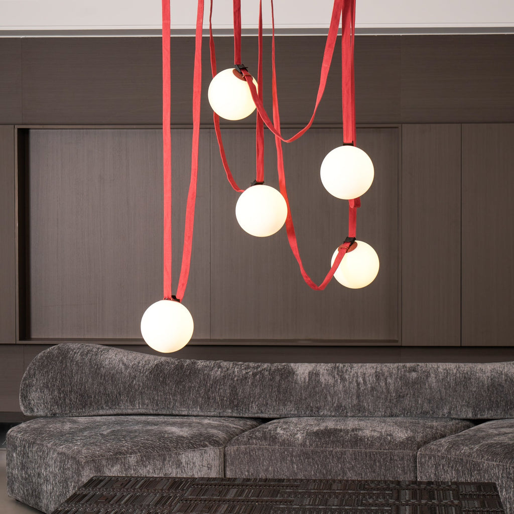 Belt pendant light leather belts and globes in a room setting