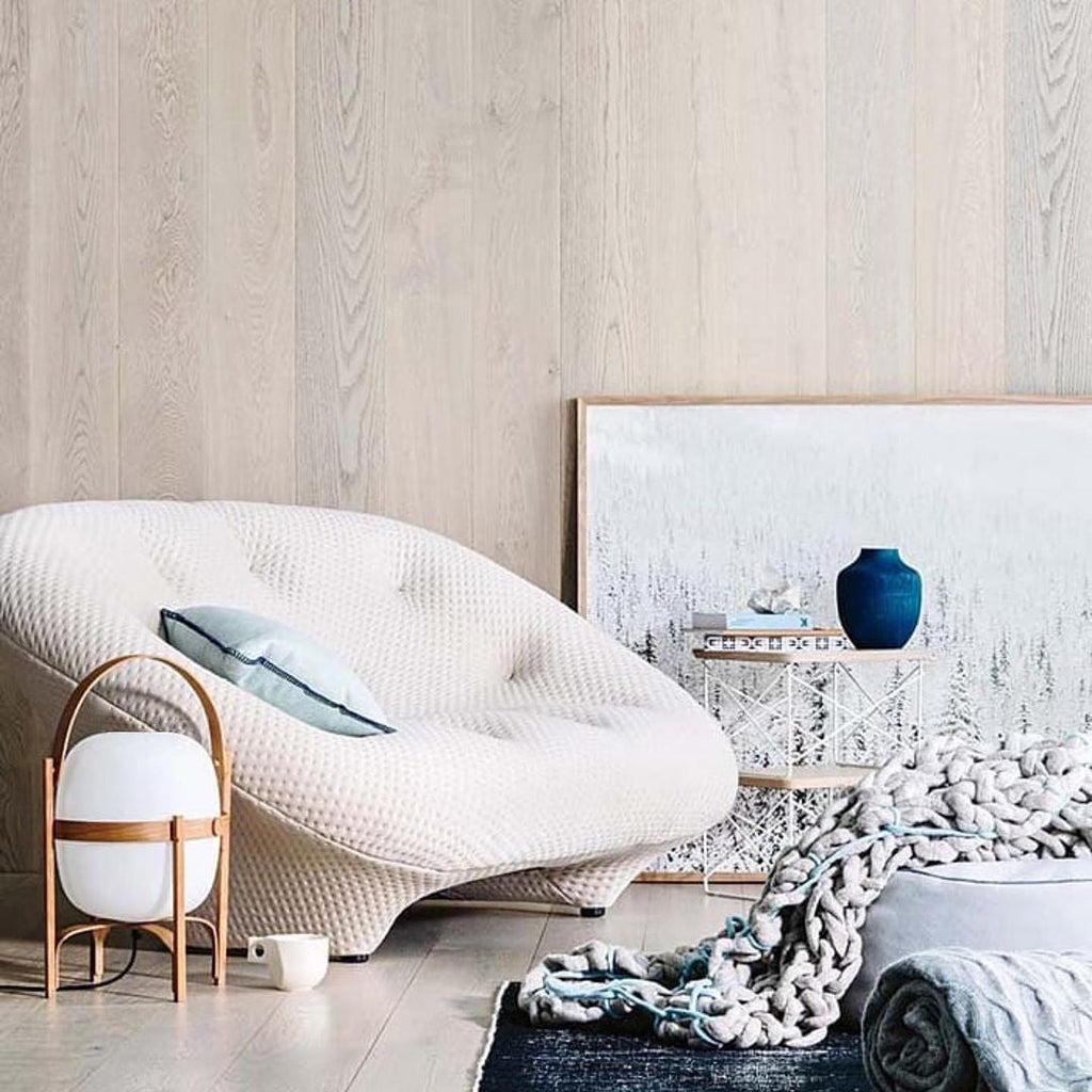 Portable wood lantern lamp glowing softly indoors