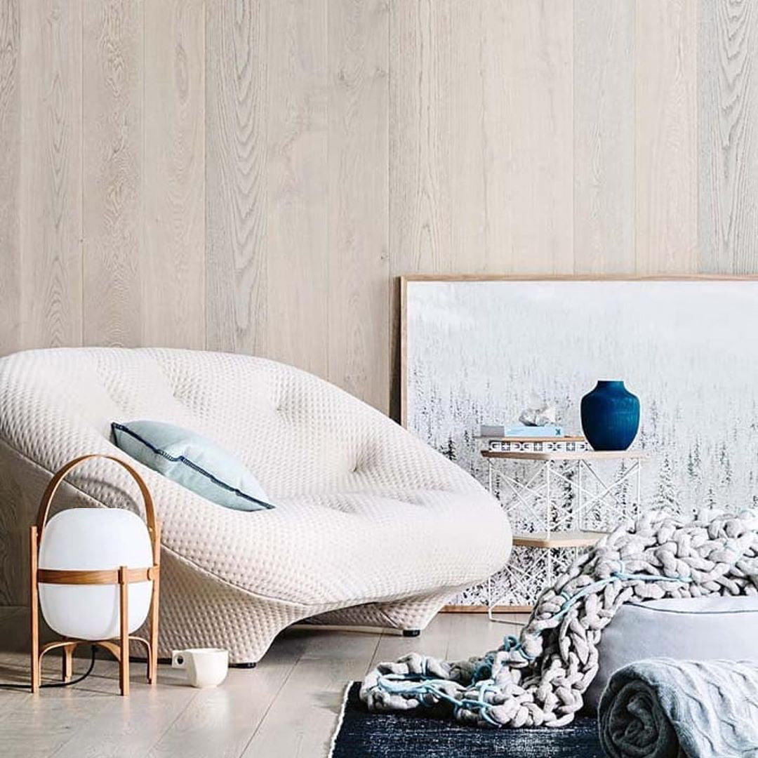 Portable wood lantern lamp glowing softly indoors