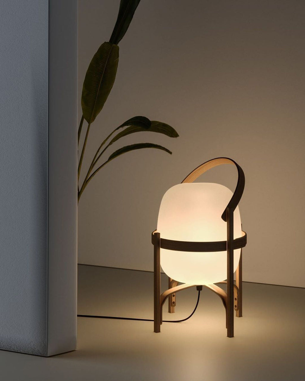 Wood and glass lantern lamp casting warm ambient light