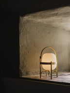 Portable lantern lamp in wood and glass on sideboard