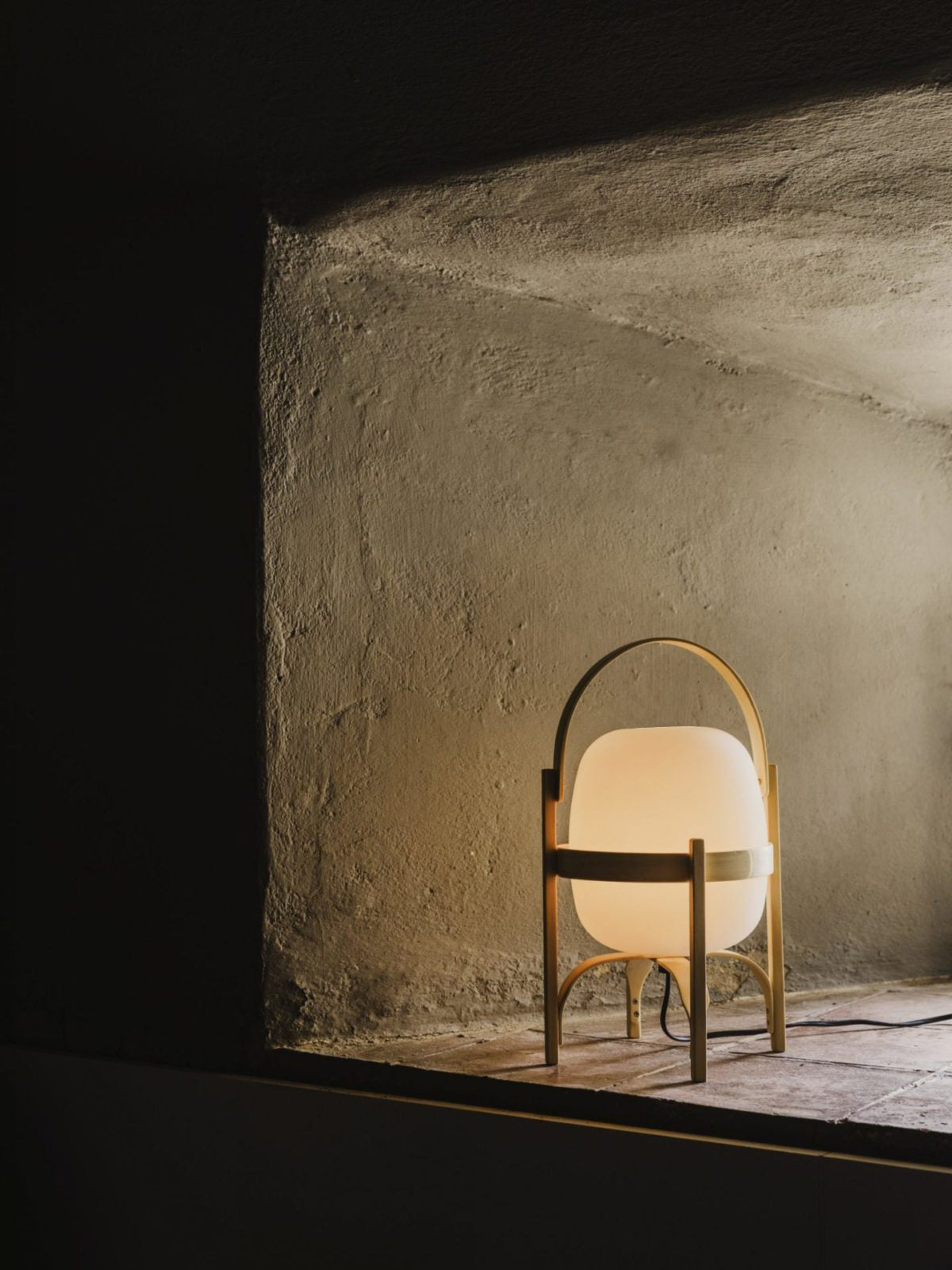 Portable lantern lamp in wood and glass on sideboard