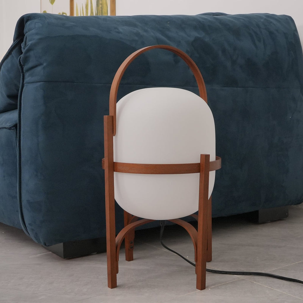 Portable wood lantern lamp glowing on the floor