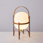 Wood-framed lantern lamp glowing on a tabletop