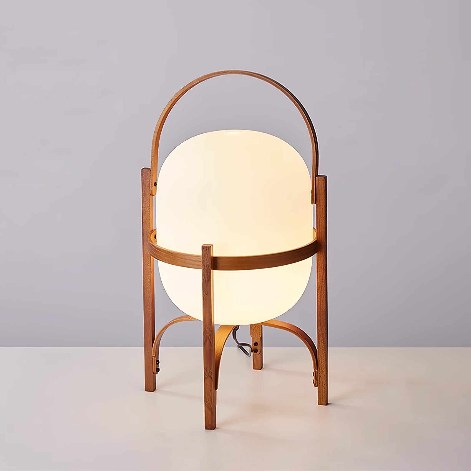 Wood-framed lantern lamp glowing on a tabletop