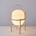 Portable wood lantern table lamp with white glass shade lit warmly
