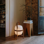 Natural wood lantern table lamp glowing softly indoors