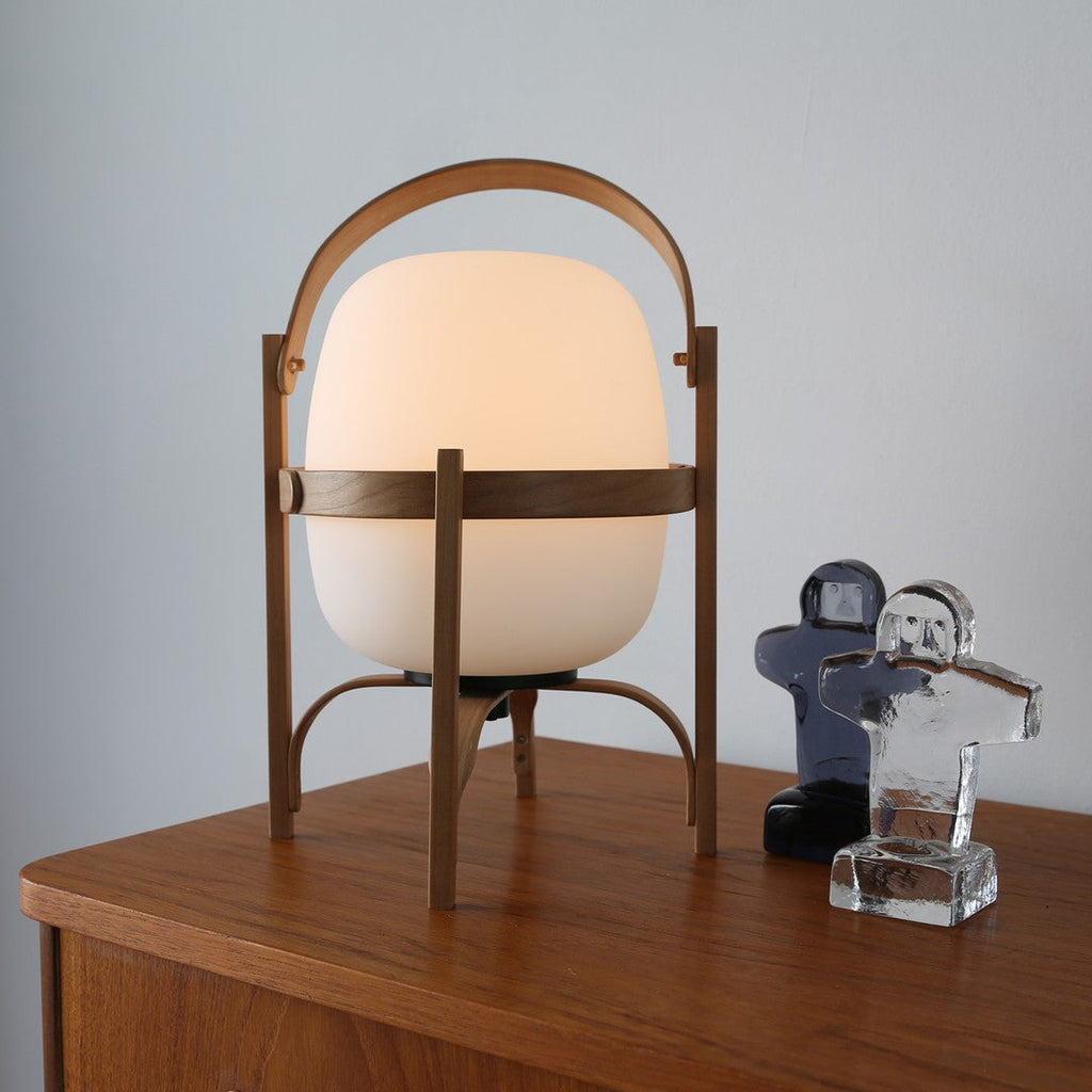 Wood-framed portable lamp with warm white glass shade