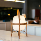 Wood and glass lantern lamp casting a warm glow