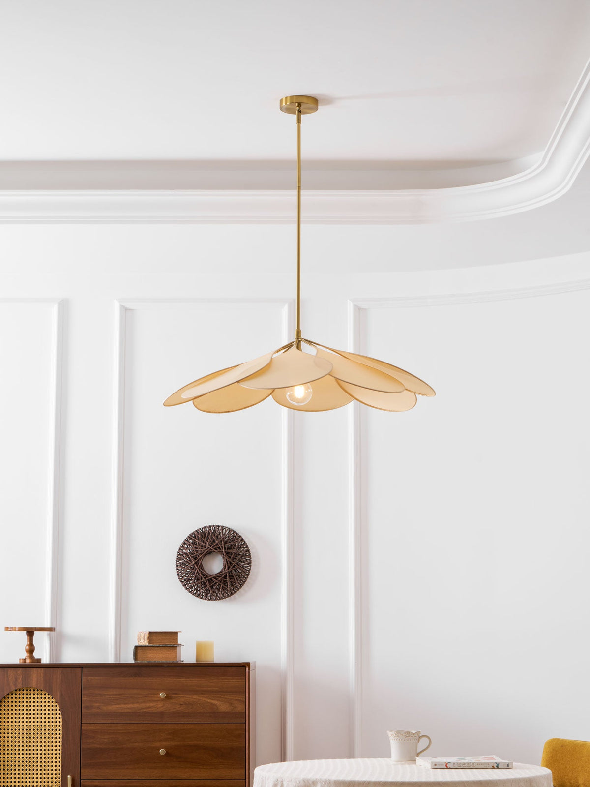 Shown from below, this Clérachic pendant lamp's beige petals fan out with its bulb visible at the centre.