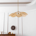 Seen from directly below, this Clérachic pendant lamp's beige petals fan out evenly around a bare bulb.