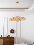 This Clérachic pendant lamp in beige petals hangs low, its bulb glowing softly beneath the fanned shade.
