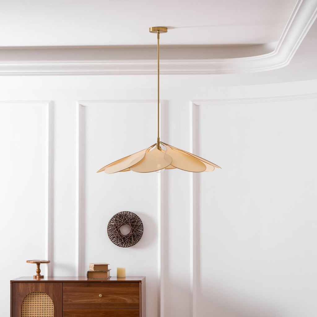This Clérachic pendant lamp in beige petals hangs above a walnut sideboard styled with a woven wall wreath.