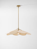 This Clérachic pendant lamp in beige petals hangs compactly on a long brass stem against a plain grey background.