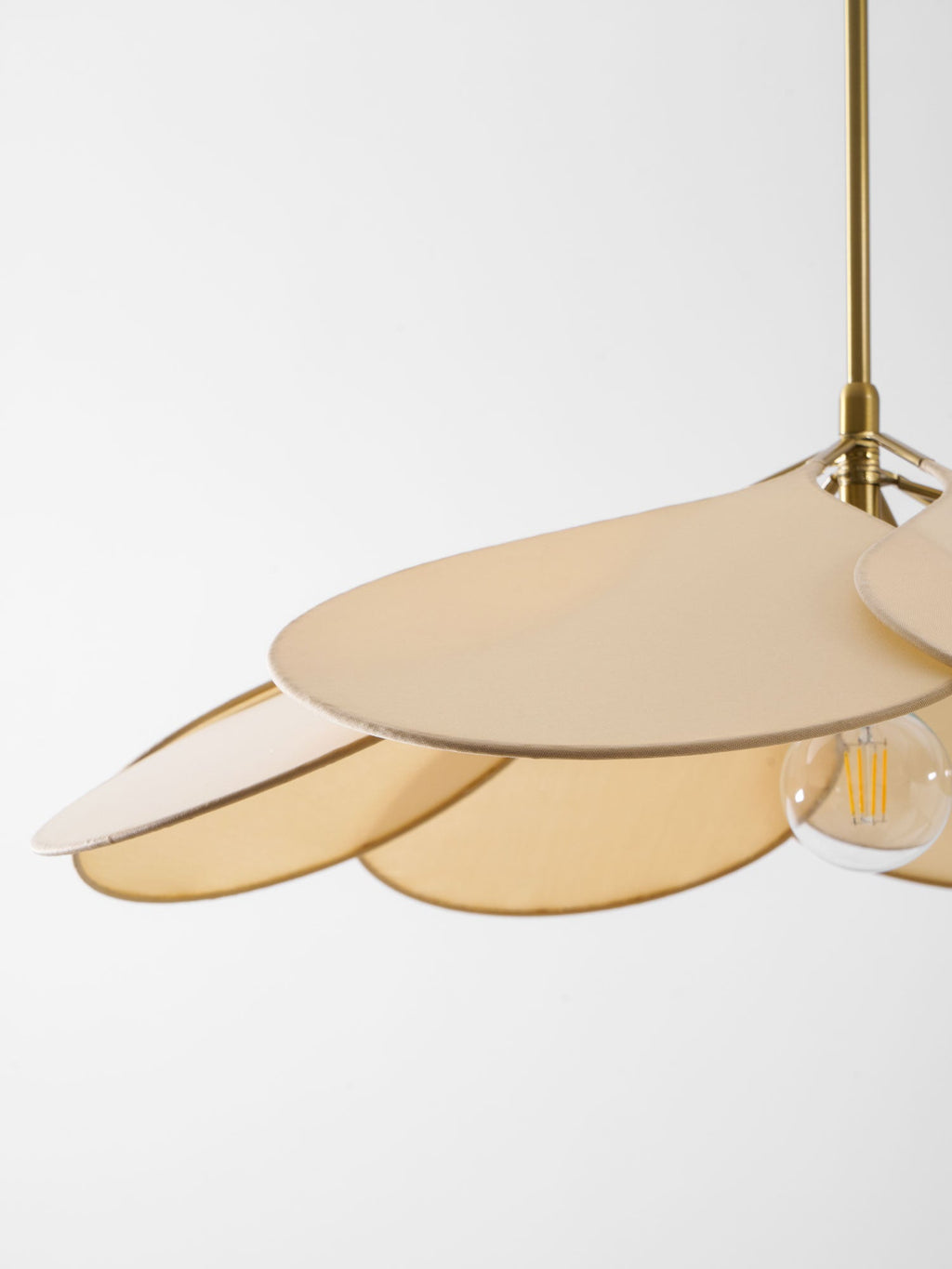 Close view of this Clérachic pendant lamp's beige petals seen from above, with its bulb just visible at the edge.