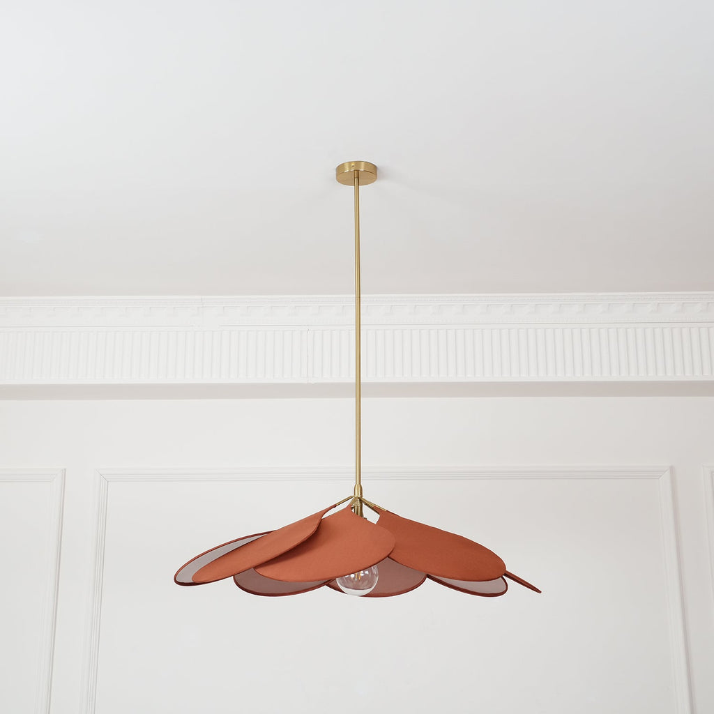 Hanging centred beneath a panelled ceiling, this Clérachic pendant lamp shows terracotta petals fanned into a wide dome.