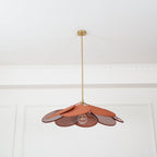This Clérachic pendant lamp's terracotta petals are shown close beneath the ceiling, with its bulb visible among the fanned shade.