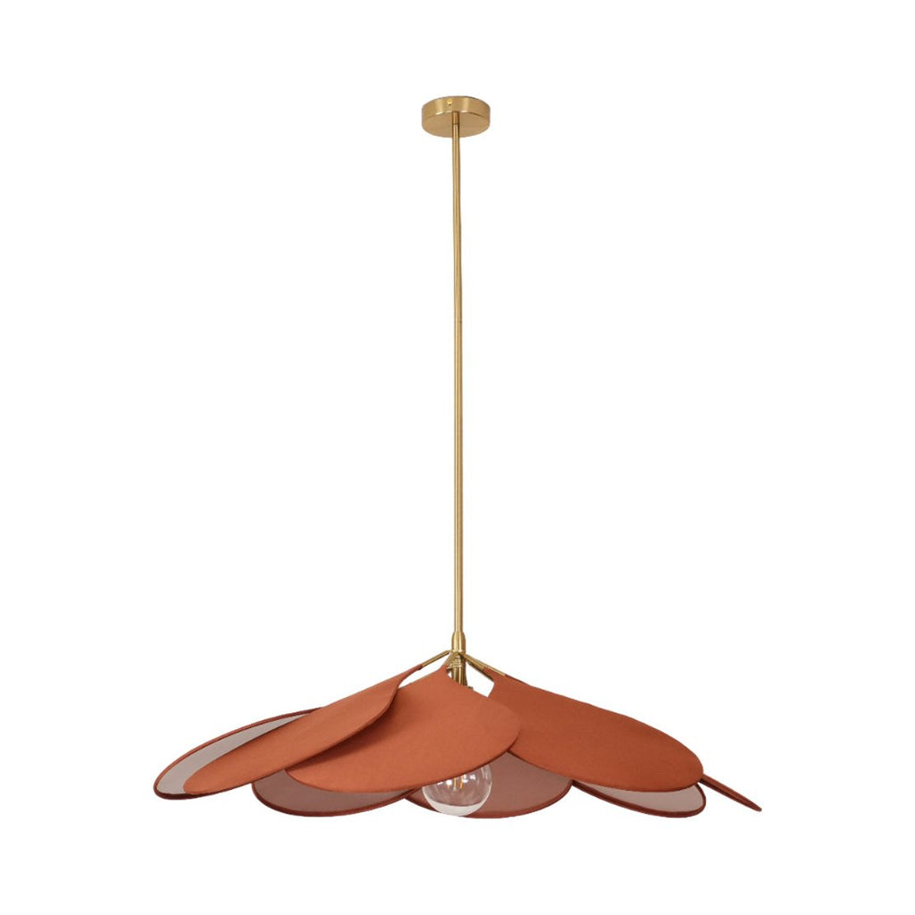 This Clérachic pendant lamp in terracotta petals hangs low on a long brass stem, its petals splayed unevenly to one side.