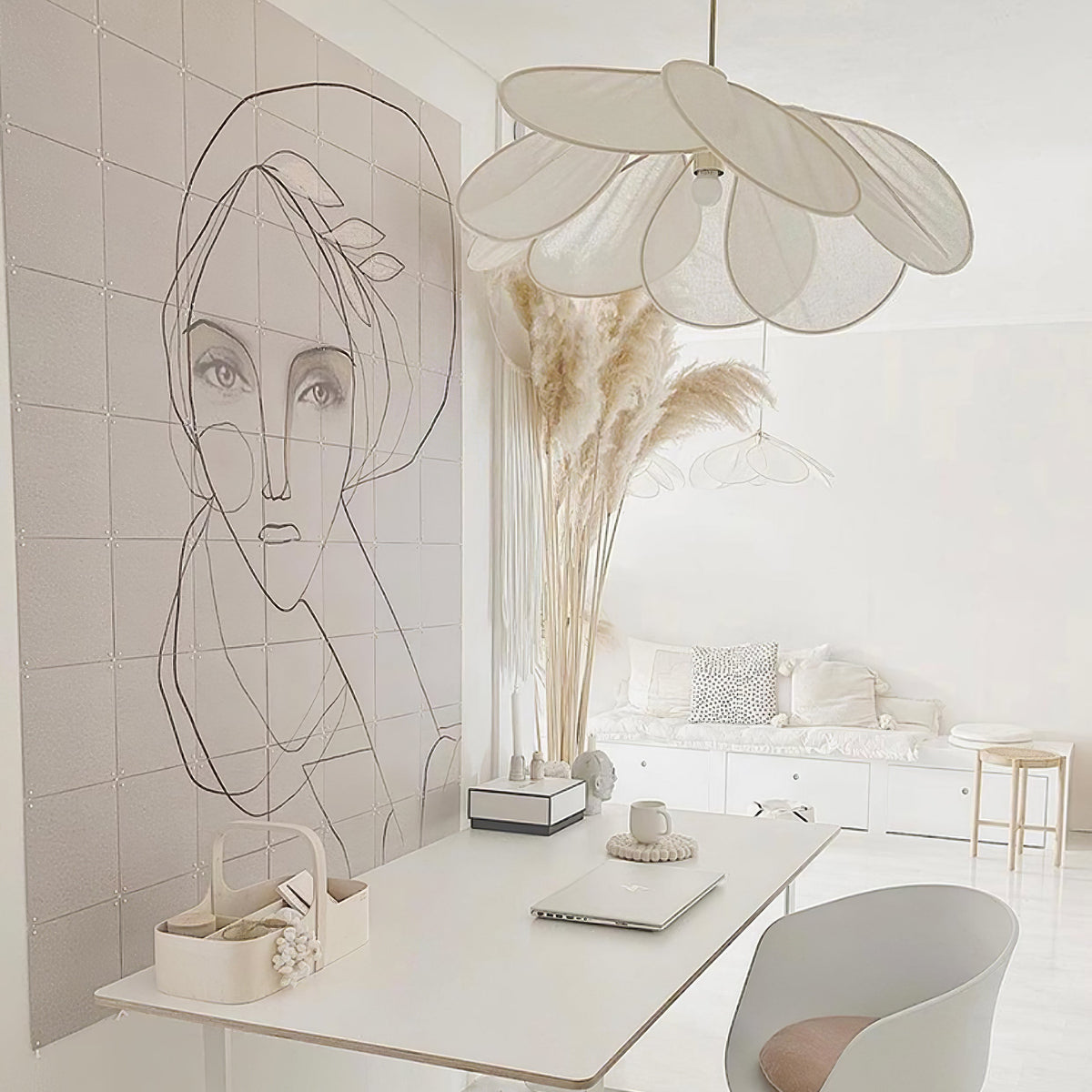 Two of these Clérachic pendant lamps in white petals hang beside a line-drawing mural and dried pampas grass on a white desk.
