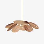 Studio shot of this Clérachic pendant lamp, its copper-toned petals fanned into a wide dome around a bare bulb on a brass rod.