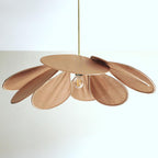 Studio shot of this Clérachic pendant lamp, its tan petals fanned into a wide dome around a central bulb on a brass stem.