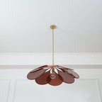 This Clérachic pendant lamp in deep red-brown petals hangs from a plain white ceiling with panel moulding.