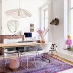 This Clérachic pendant lamp in cream fabric petals hangs above a home office desk with a round mirror and a computer monitor.