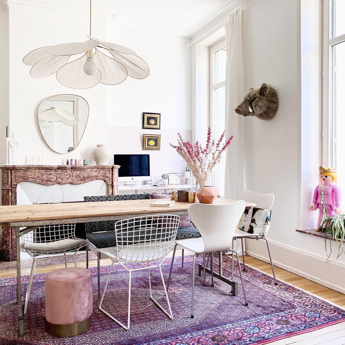 This Clérachic pendant lamp in cream fabric petals hangs above a home office desk with a round mirror and a computer monitor.
