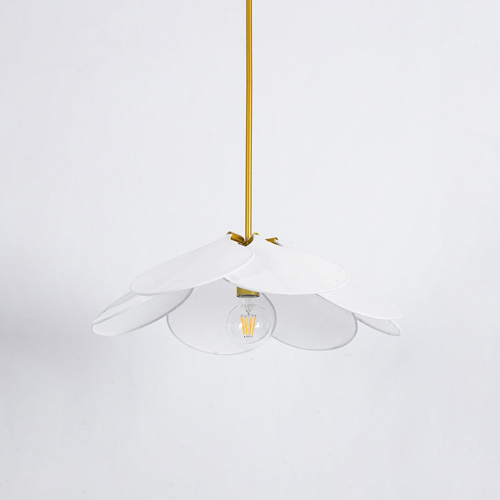 Studio shot of this Clérachic pendant lamp, its white petals fanned around a bare bulb on a brass stem.