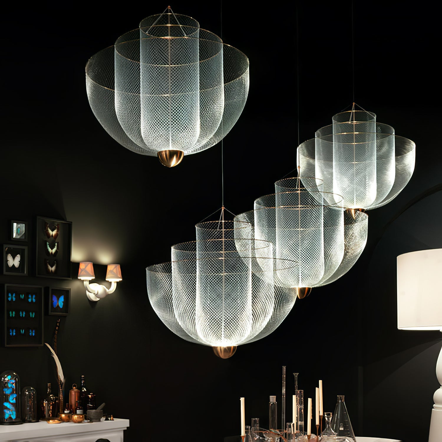 Steel wire pendant light frame catching light along its curves