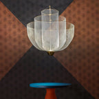 Wirework pendant light hanging above an interior setting