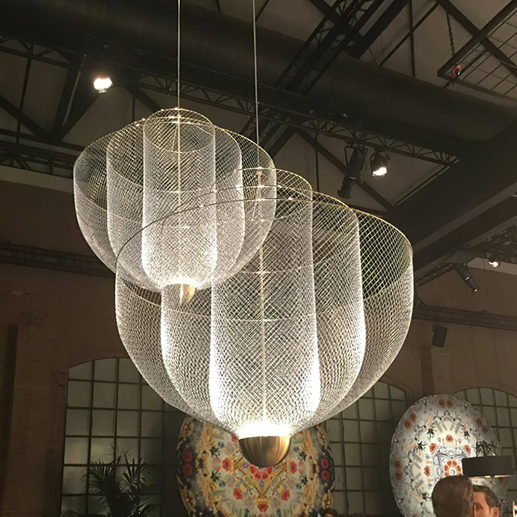 Spherical wire pendant light lit warmly in a living space
