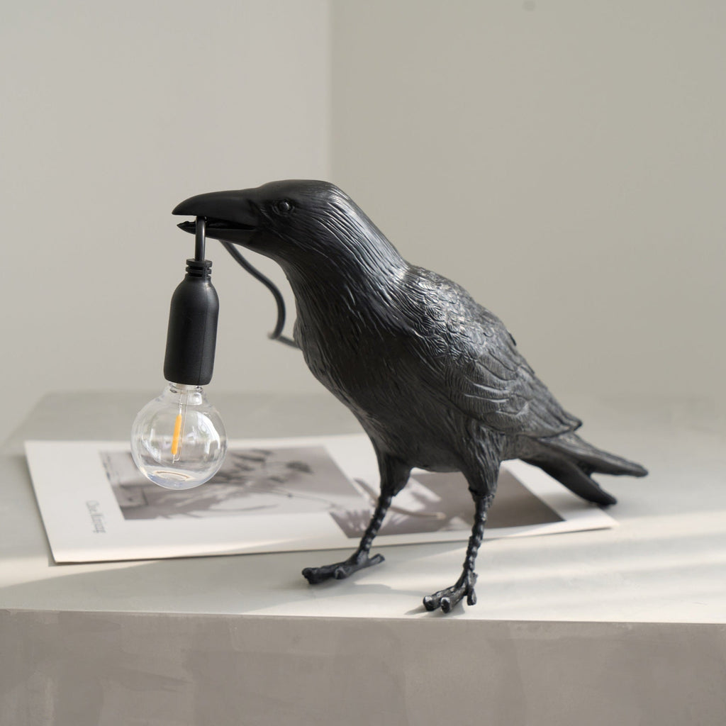 Raven resin lamp detail of beak and warm Edison bulb