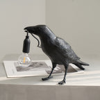 Raven resin lamp detail of beak and warm Edison bulb