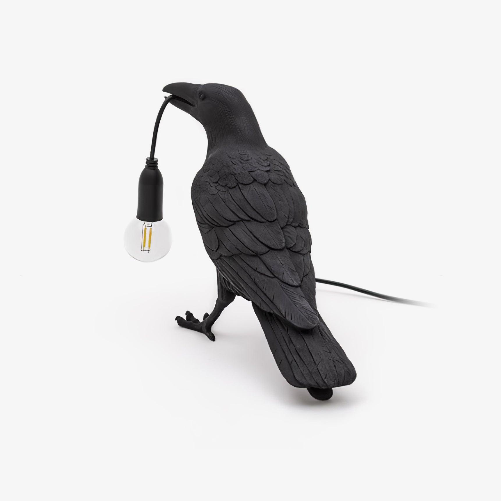 White resin raven lamp perched with an Edison bulb