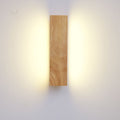Wooden LED wall light lit head-on, washing warm light up and down the wall on either side