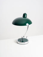 Photographed unlit on a plain white backdrop, this green Clérachic desk lamp stands at full length.