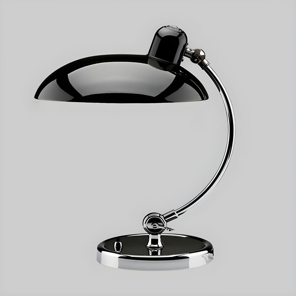 Set against a plain grey backdrop, this black Clérachic desk lamp shows its domed shade in profile.