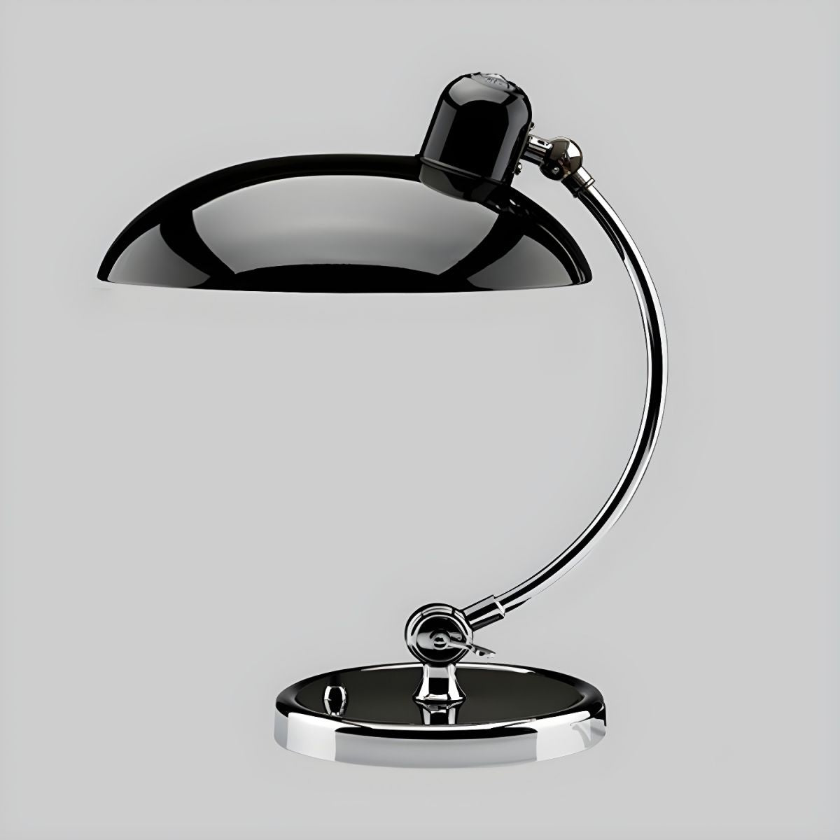 Set against a plain grey backdrop, this black Clérachic desk lamp shows its domed shade in profile.