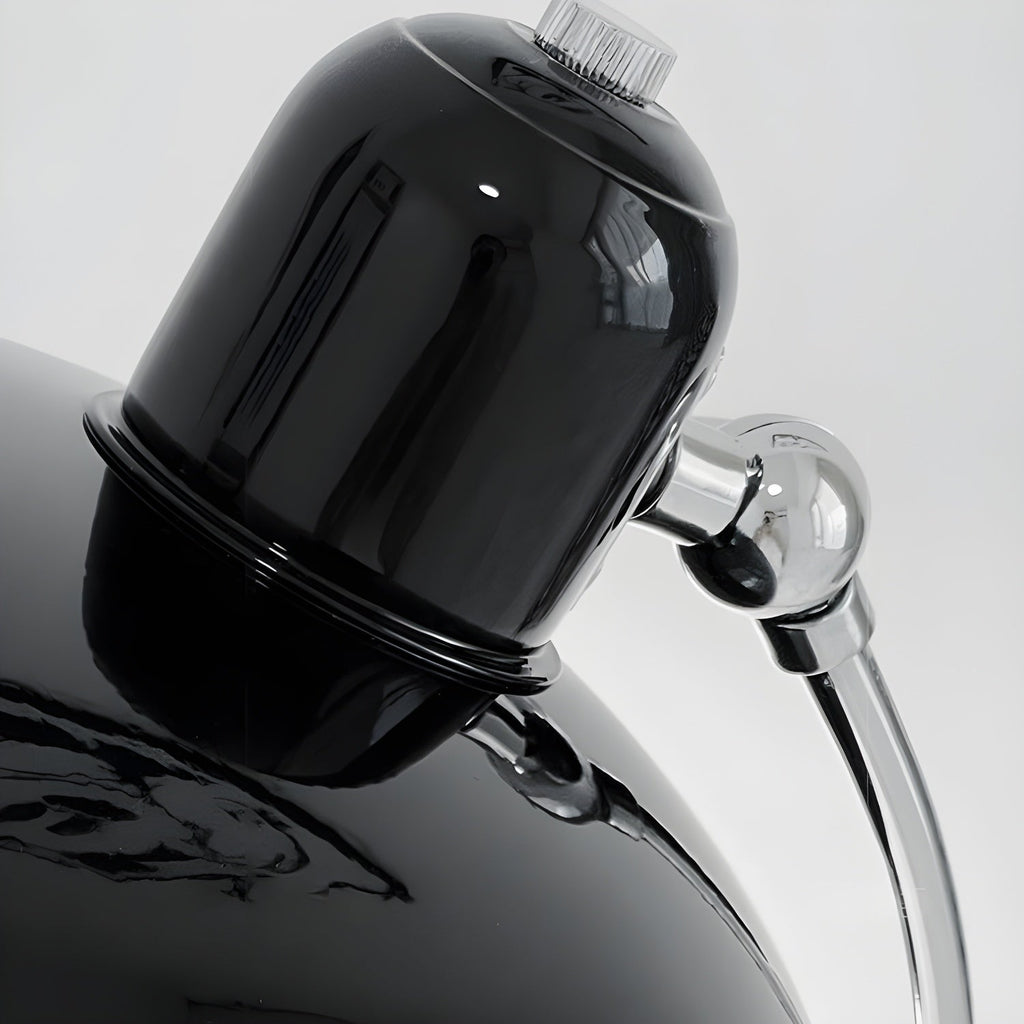 Close view of the glossy black dome shade and chrome joint on this Clérachic desk lamp.