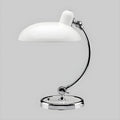 A white Clérachic desk lamp with a chrome base, shown on a plain grey backdrop.