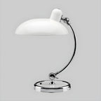 A white Clérachic desk lamp with a chrome base, shown on a plain grey backdrop.
