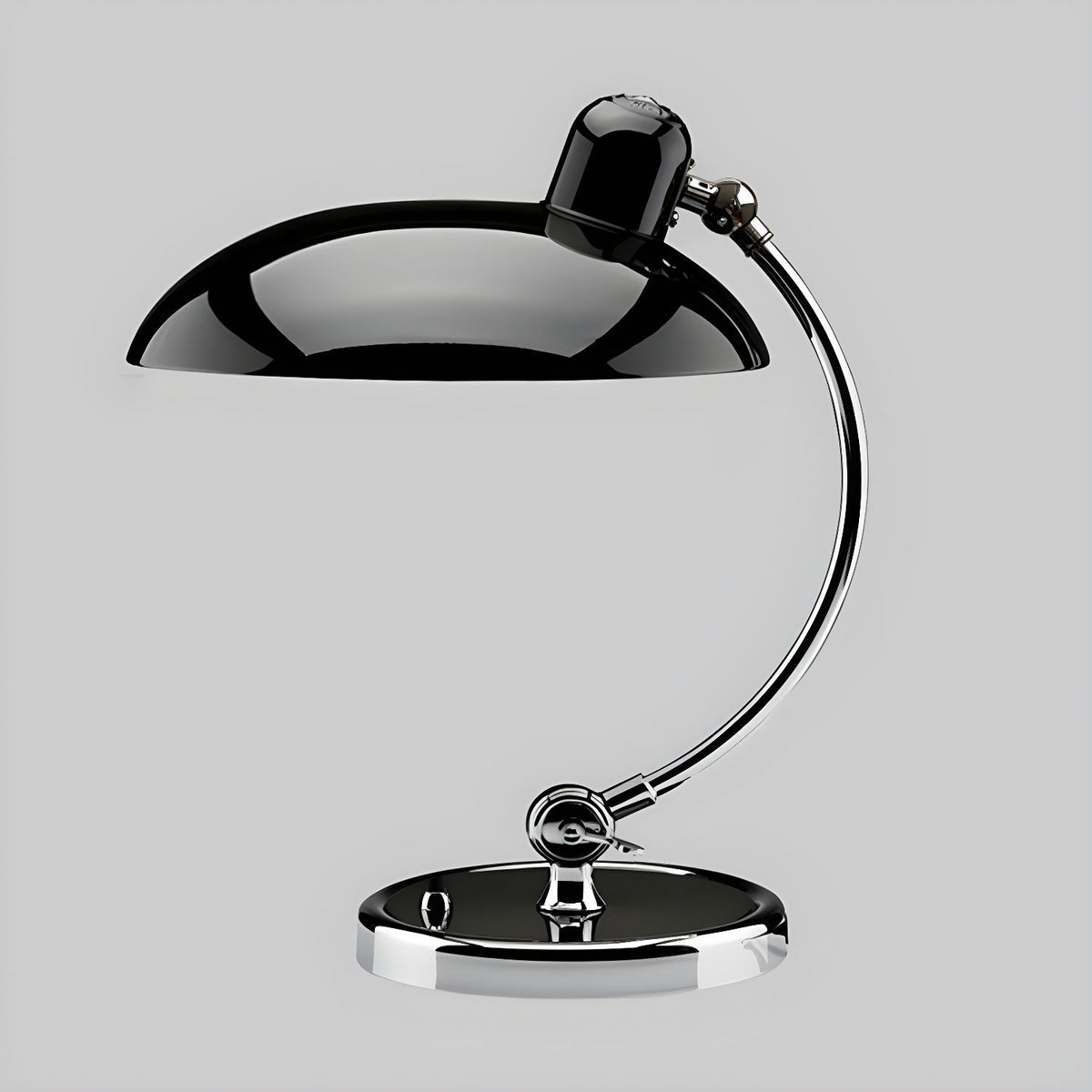 Photographed on a plain grey backdrop, this black Clérachic desk lamp stands at full length.