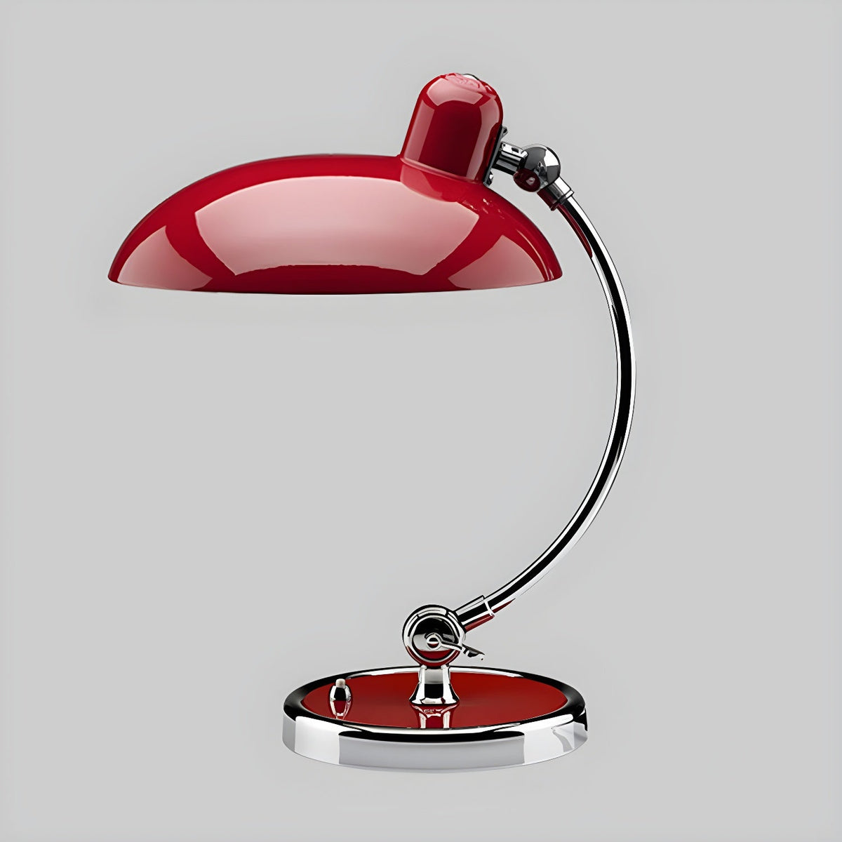 A red Clérachic desk lamp with a matching red base, shown on a plain grey backdrop.