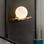 The lit Clérachic sconce is mounted beside a dark curtained doorway, with a teal accent box on the shelf below.