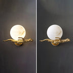 Side-by-side comparison of the Clérachic sconce in warm and cool white light, both mounted on a dark wall.