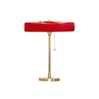 Gold base table lamp with spun metal shade lit warmly