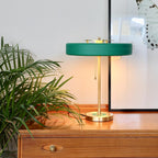 Spun metal table lamp with coloured shade ring detail