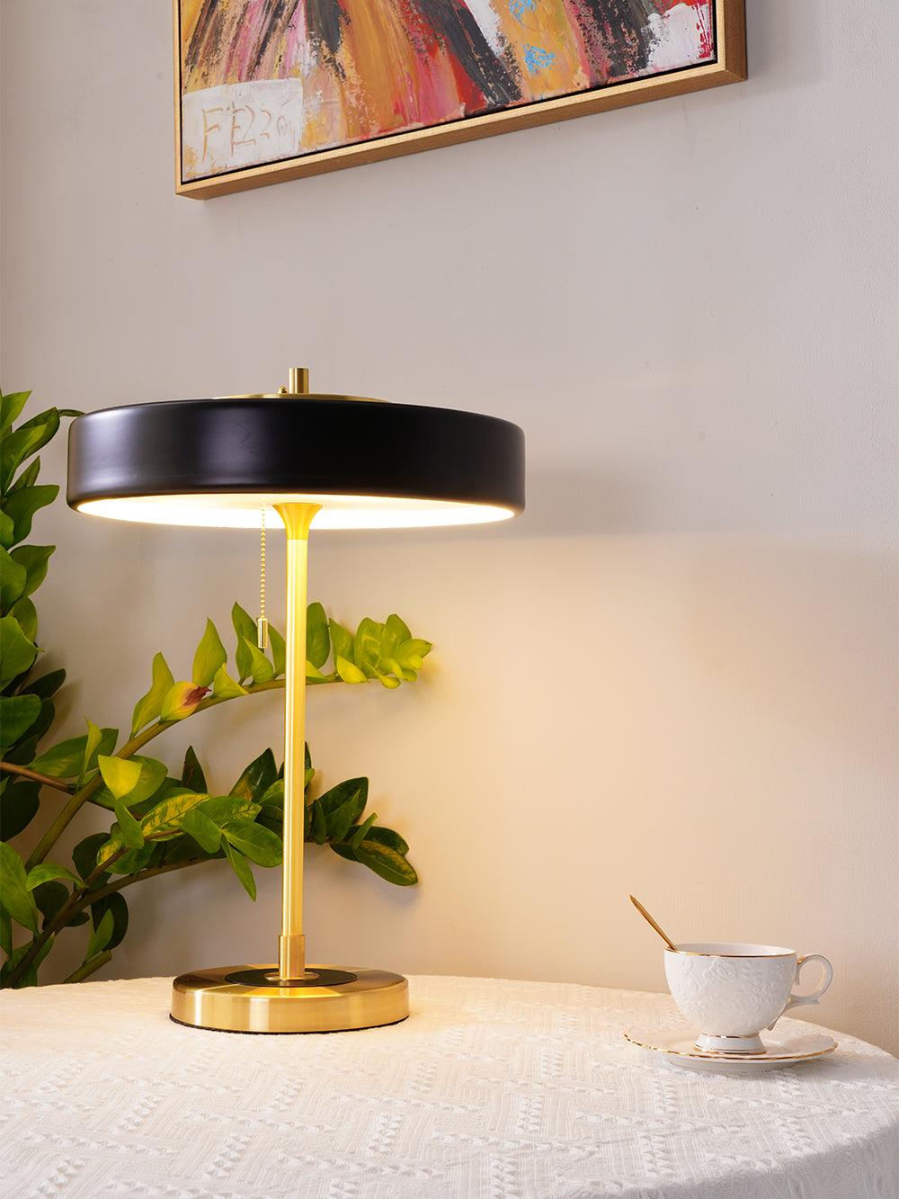 Table lamp with spun metal shade and iron base detail